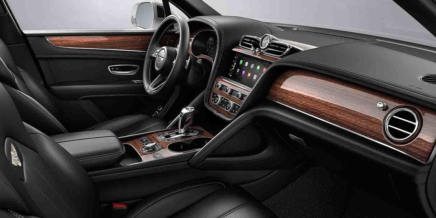 Bentley Firenze Bentley Bentayga EWB interior with a Crown Cut Walnut veneer, view from the passenger seat over looking the driver's seat.