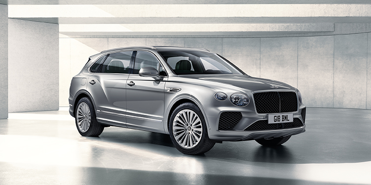 Bentley Firenze Bentley Bentayga Extended Wheelbase SUV front three quarter in Moonbeam paint with a grey background
